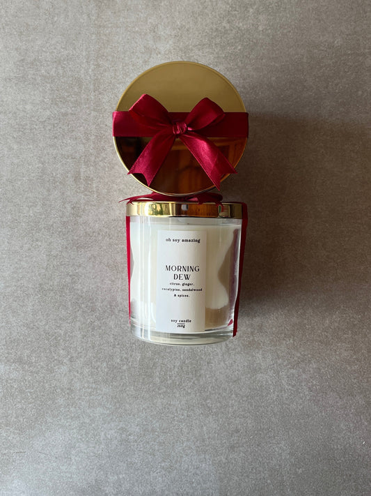 Candle with a red bow on a gray background